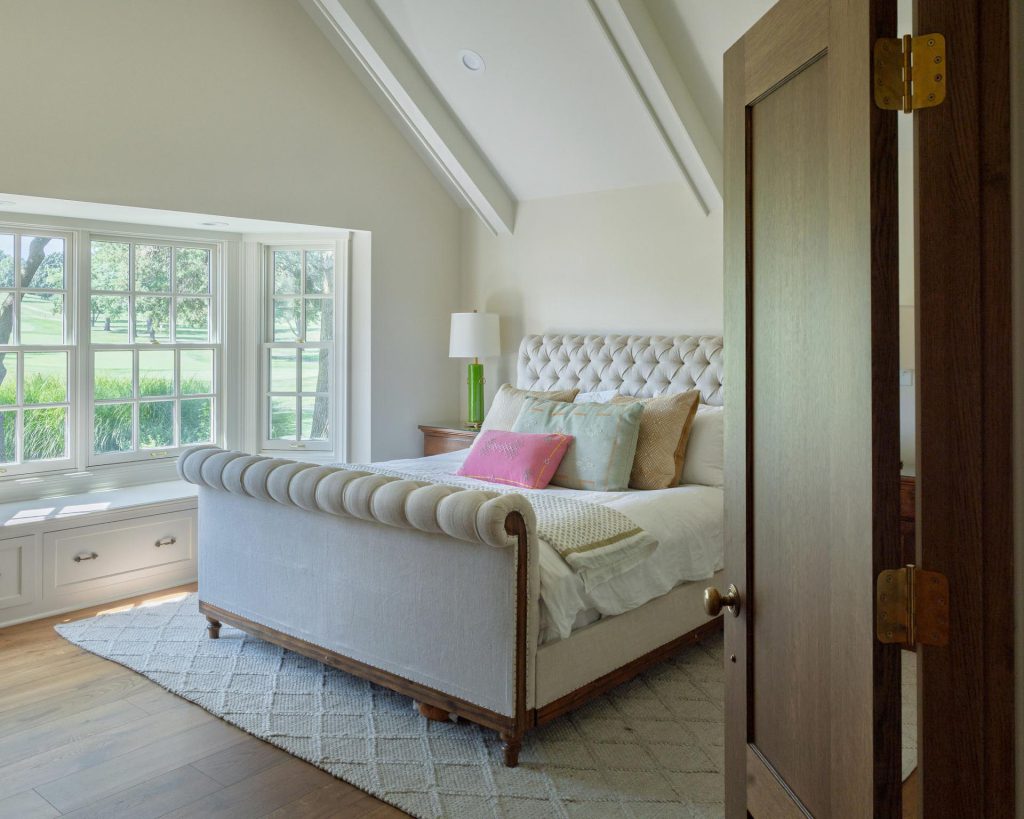 Primary bedroom with vaulted ceiling and window seat after a whole-home remodel in Lawrence, Kansas